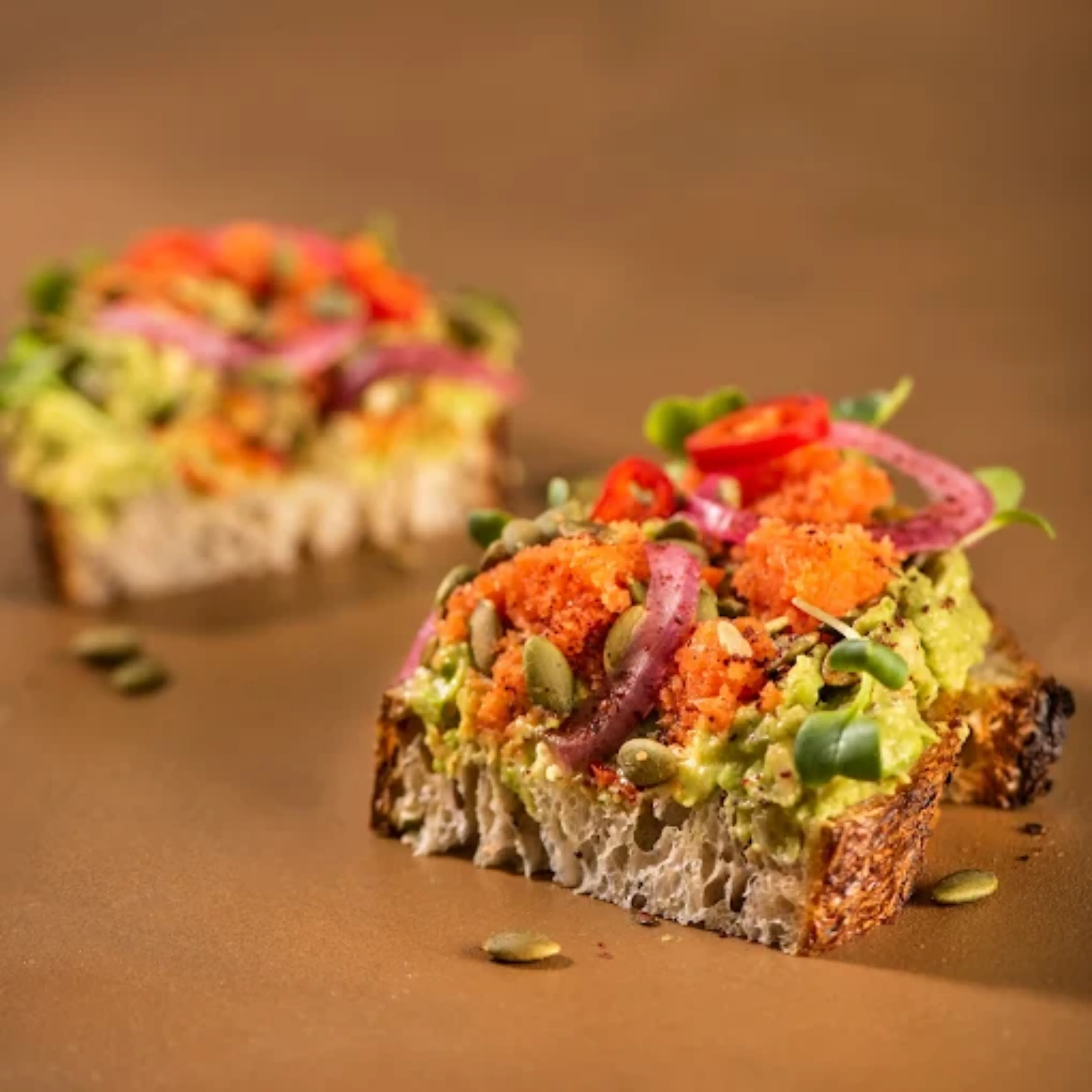 Artisan open-face sourdough toast with avocado and fresh toppings